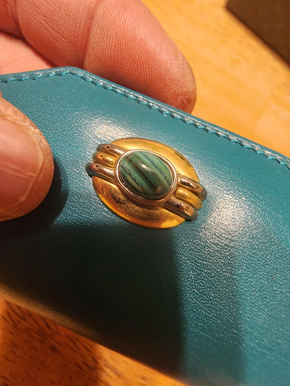 vintage Gucci teal leather key case featuring a distinctive cabochon stone